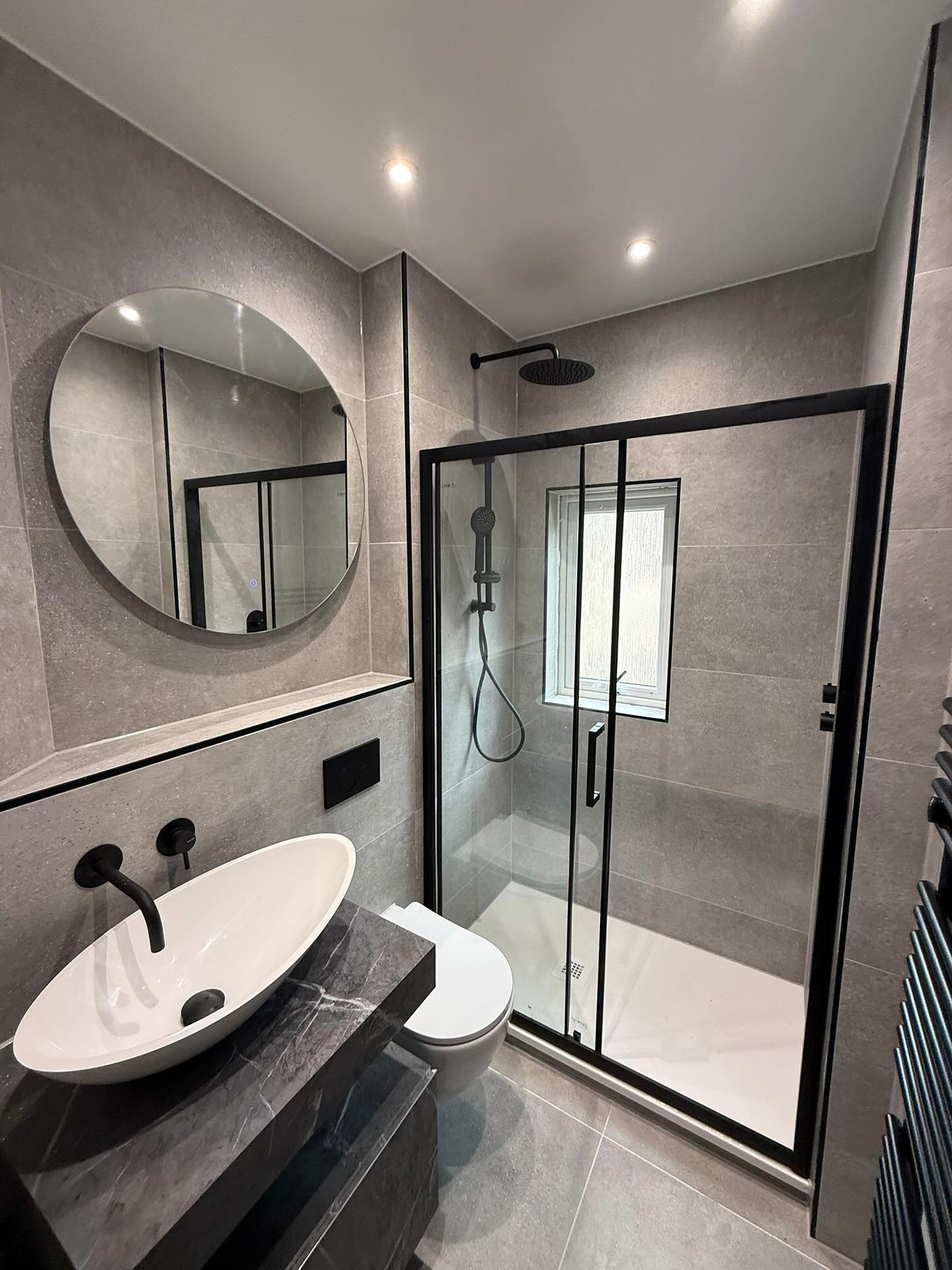 Bathroom with walk-in shower and vanity by CDM Plumbing