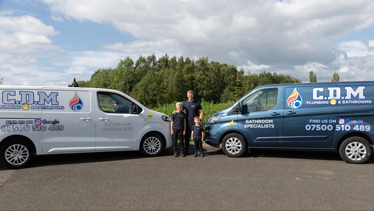 The CDM Plumbing and Bathrooms team and vans